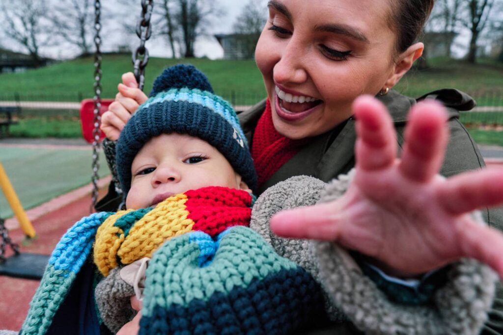 Child trying to grab the camera during a family photo session and not ignoring the photographer