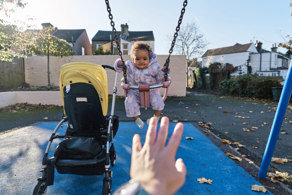 Meaningful family photos include you the parent. I included myself by putting my own hand in the frame as I was photographing how I pushed my child on the swing. 
