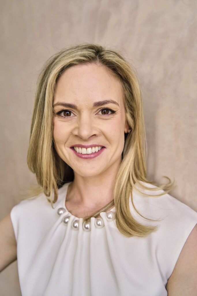 Natural headshot of a woman entrepreneur in London branding session, showing unretouched skin and confident expression