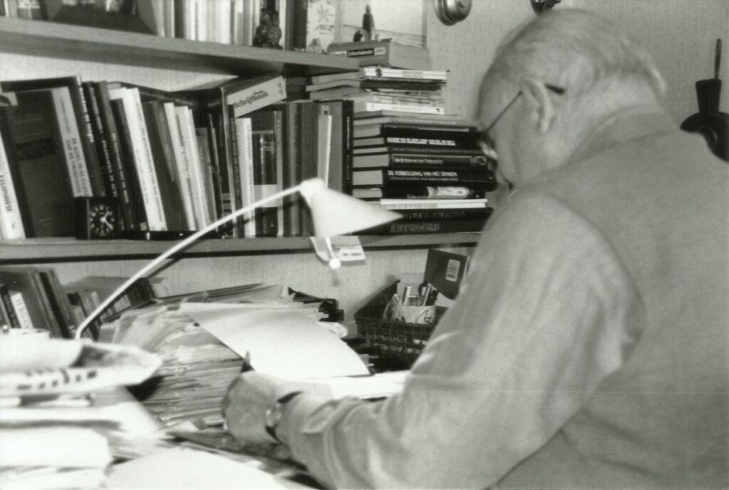 Grandfather sitting at his desk writing captured by his teen granddaughter photographer Saskia Albers.